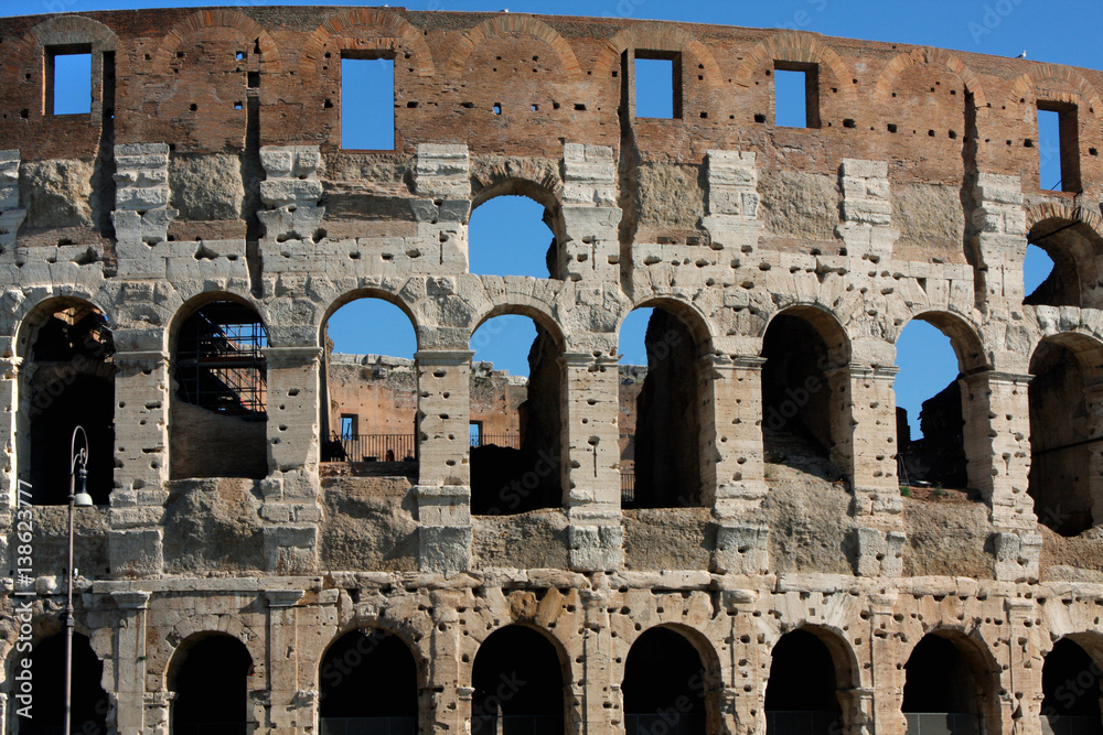 Coloseum against bright bluse sky in Rome Italy