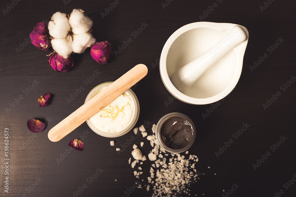 Cosmetics and flowers on a black background Cosmetics and flowers on a black background