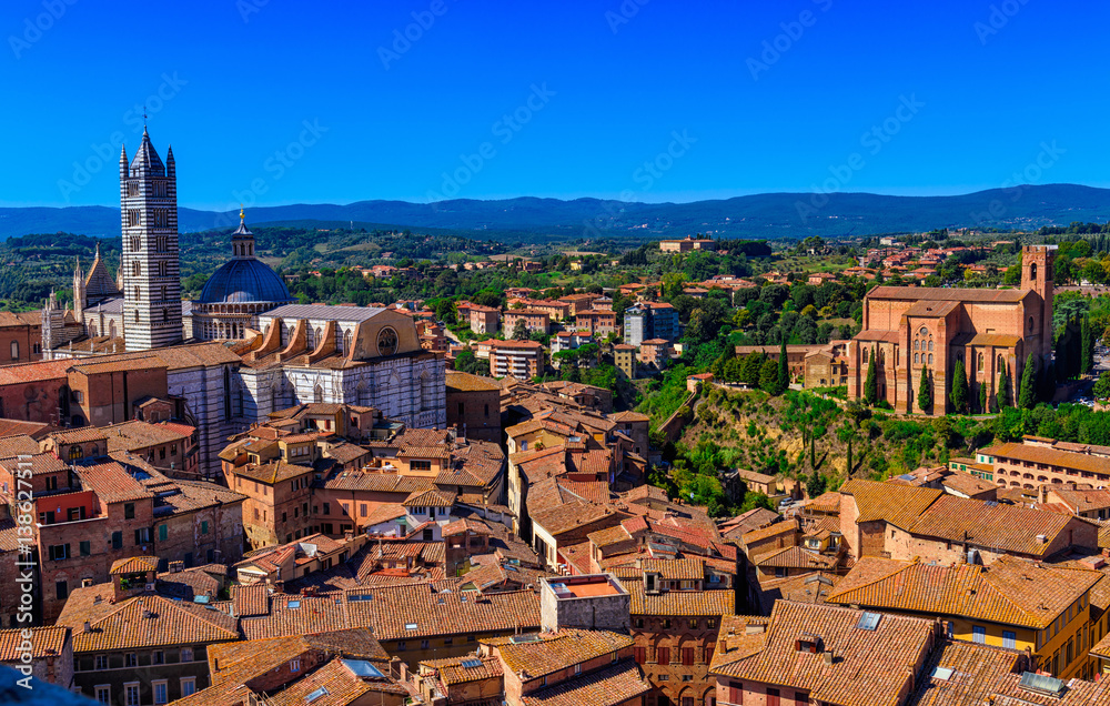 View of Siena and Basilica of San Domenico (Basilica Cateriniana) and Siena Cathedral Santa Maria Assunta (Duomo di Siena) in Siena, Tuscany, Italy