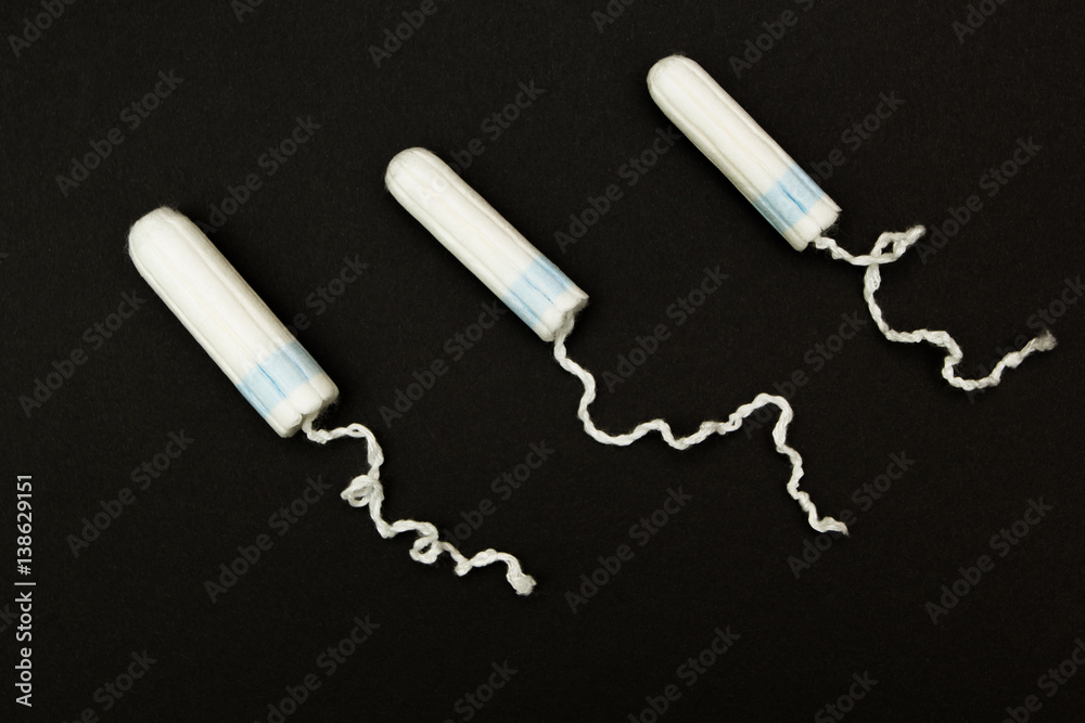 Three tampon on a black background. Three tampon on a black background.