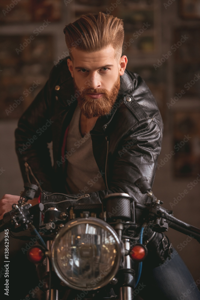 Guy in motorbike repair shop