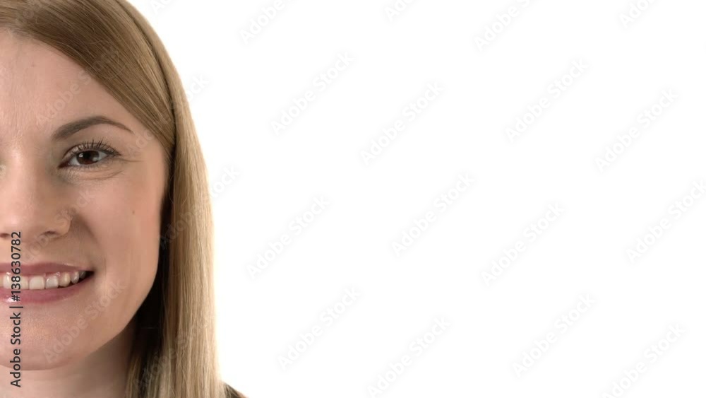 Beautiful attractive young woman smiling into camera. Half face. Isolated white background. Beautiful attractive young woman smiling into camera. Half face. Isolated white background.
