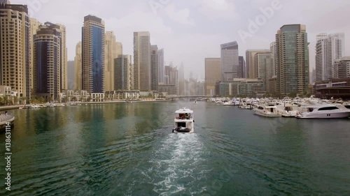 beautiful aerial view on bay with yachts and embankment among the skyscrapers in Dubai, UAE photo