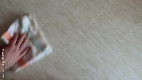 hand wipes towel table and then puts on his plate with pizza.