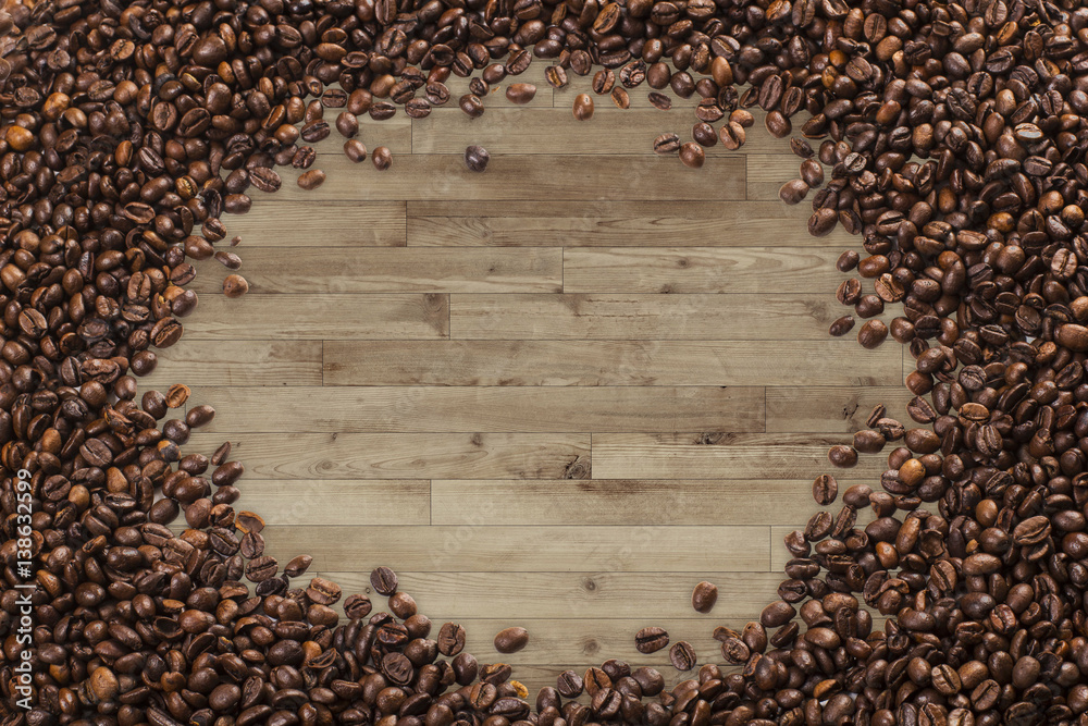 Fototapeta premium Frame of coffee beans, wood planks background
