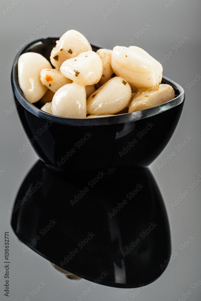 Garlic cloves on black vertical