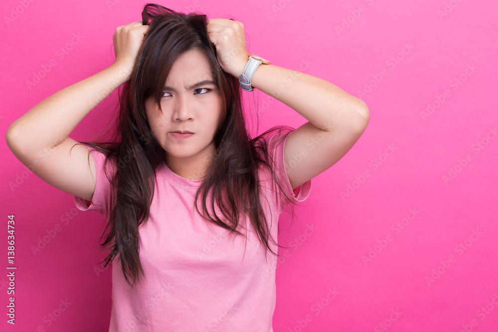 Angry woman screaming out and pulling her hair Angry woman screaming out and pulling her hair