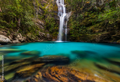 Panoramic photo landscape of a turquoise waterfall hidden in the tropical jungle in Brazil