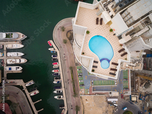Photography Aerial view of pool of water on the roof of a skyscraper in Dubai, UAE