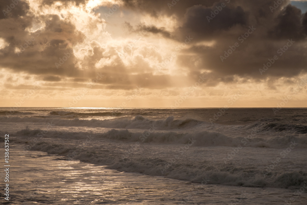 Storm clouds at sunset over a rough ocean Storm clouds at sunset over a rough ocean