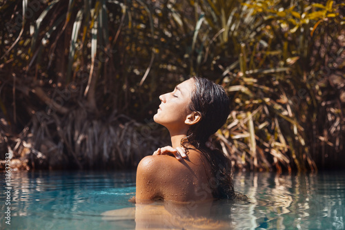 attractive young woman taking bath in wild lake © zolotareva_elina