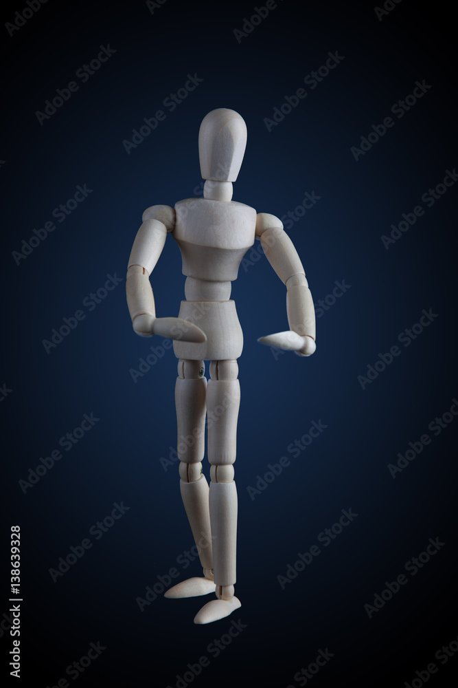 Wooden figurine flexing muscles in bodybuilder pose on dark background