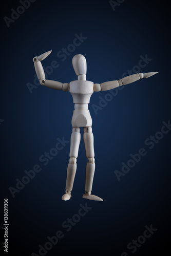 Wooden figurine flexing muscles in bodybuilder pose on dark background