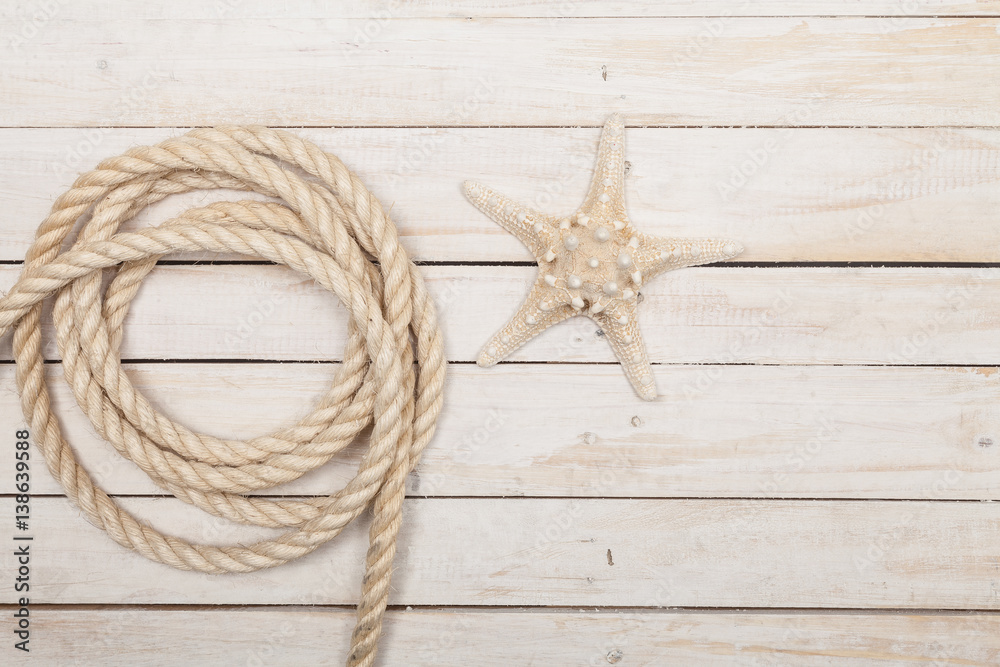 Rope and starfish on wooden background Rope and starfish on wooden background