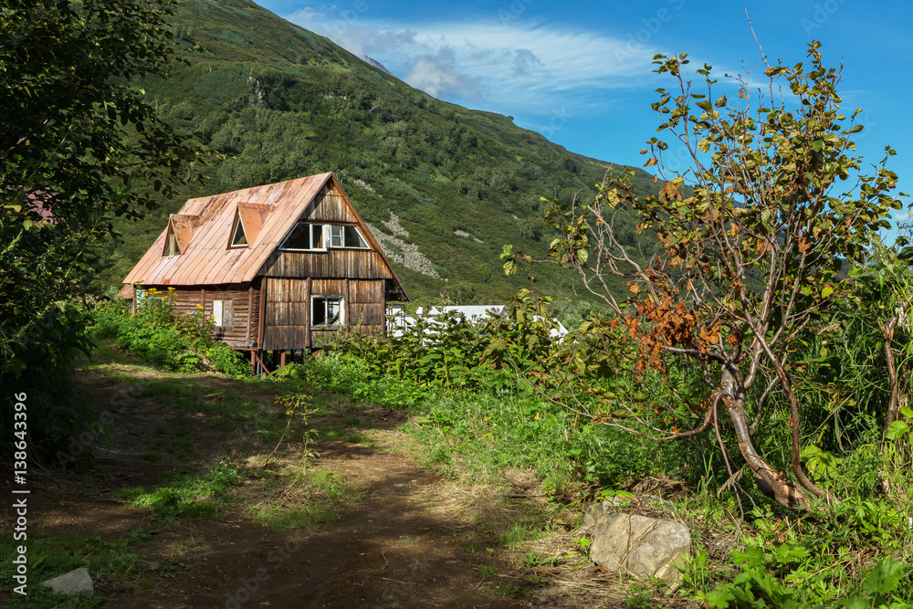 Old wooden house in brookvalley Spokoyny at the foot of outer north-eastern slope of caldera volcano Gorely. Old wooden house in brookvalley Spokoyny at the foot of outer north-eastern slope of caldera volcano Gorely.