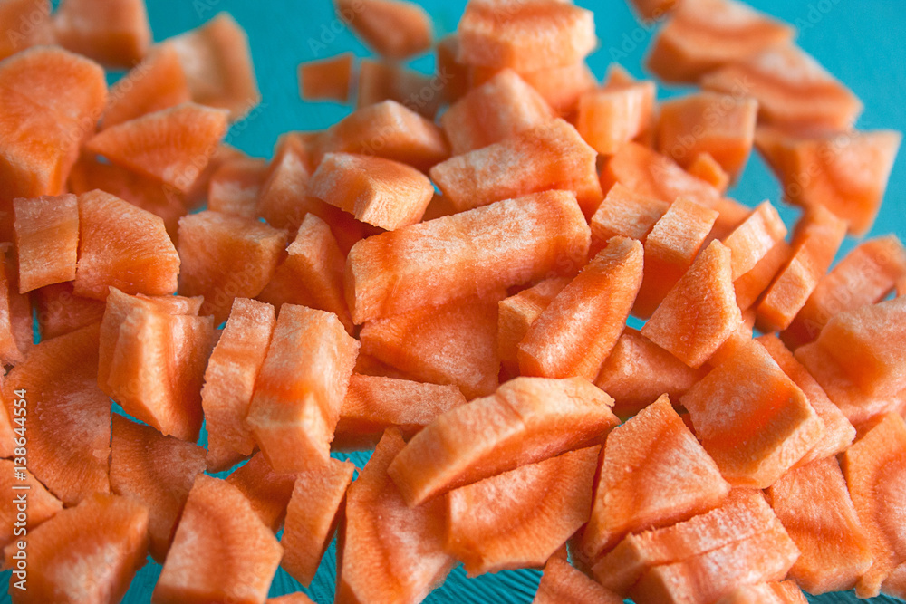 sliced carrots closeup on blue cutting Board sliced carrots closeup on blue cutting Board
