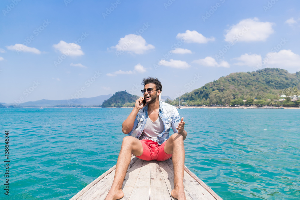 Young Man Tourist Sail Long Tail Thailand Boat Speak Cell Smart Phone Call Ocean Sea Vacation Travel Trip Exotic Holiday