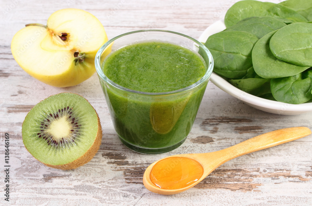 Ingredients and fresh cocktail from spinach, apple and kiwi on wooden background, healthy nutrition Ingredients and fresh cocktail from spinach, apple and kiwi on wooden background, healthy nutrition