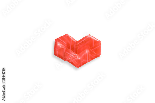 The shape of a heart made from the folded red tube on white background.