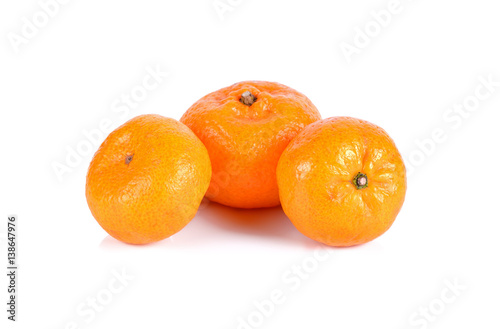 Three small oranges isolated on white background