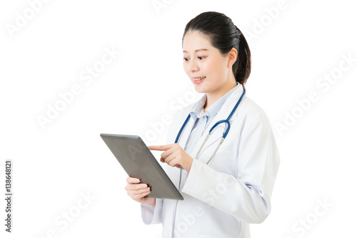 beauty asian doctor using digital tablet pad touch screen