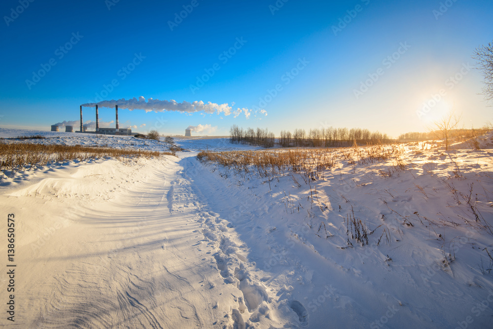 Pipes Factory on a background of winter field
