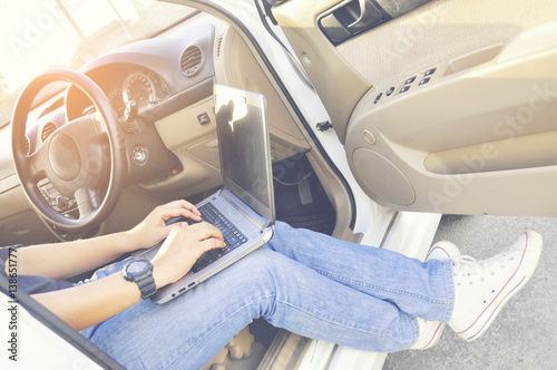 Wallpaper Mural Young, beautiful woman seat of the white car working on her laptop, ,Working Outdoor ,Business Concept Torontodigital.ca
