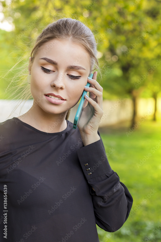 portrait of a serious beautiful woman talking on the phone on street portrait of a serious beautiful woman talking on the phone on street