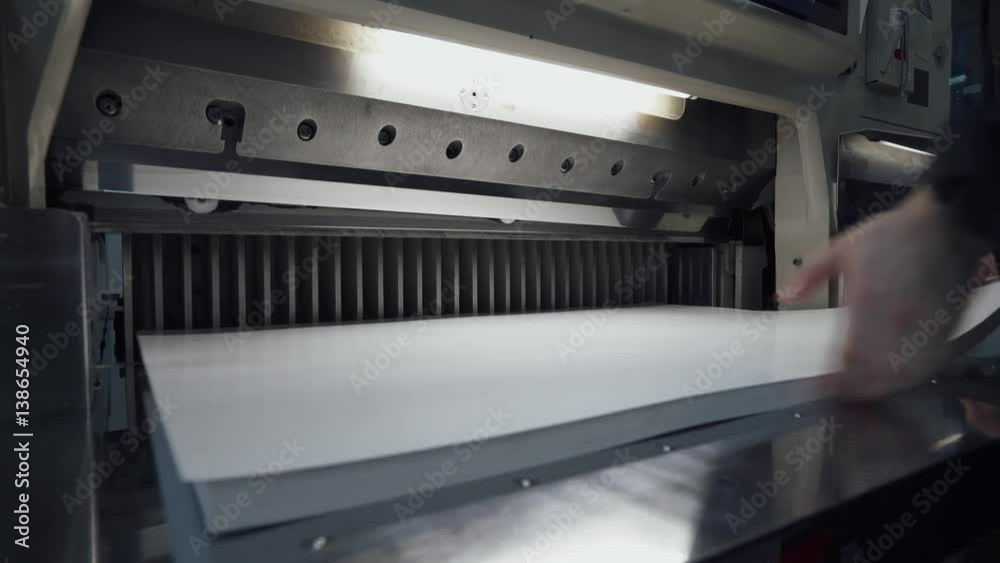 Printing press, paper cutting on the cutting machine, printing production. 4k footage.
