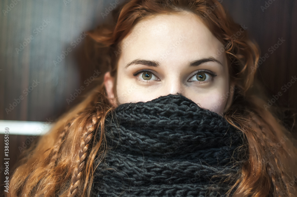 portrait of a woman with a black scarf covering the face, thick red hair with braids sitting in cafe portrait of a woman with a black scarf covering the face, thick red hair with braids sitting in cafe
