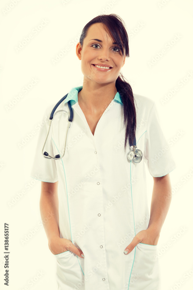 Female doctor with stethoscope standing at office and smiling at camera Female doctor with stethoscope standing at office and smiling at camera