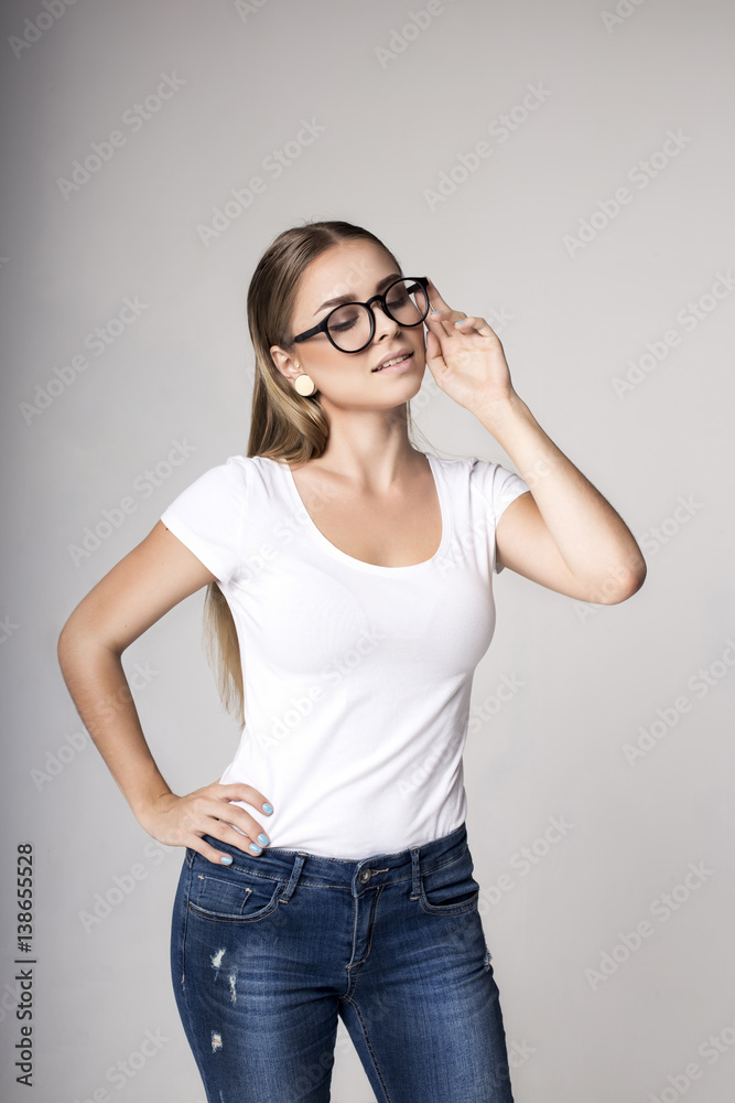 Modern woman in blank white t-shirt over gray background