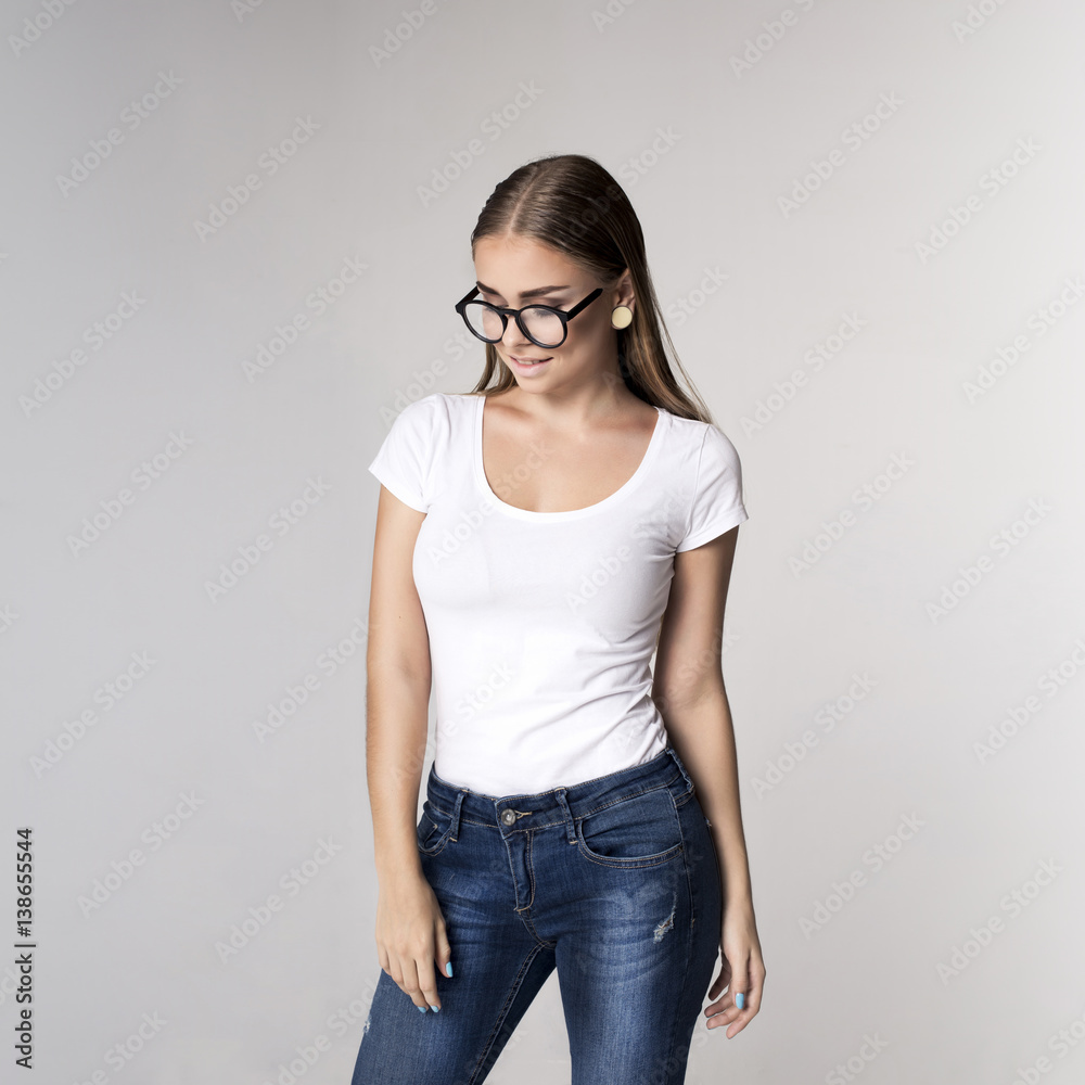 Lovely young girl wearing in a white blank t-shirt and jeans Lovely young girl wearing in a white blank t-shirt and jeans