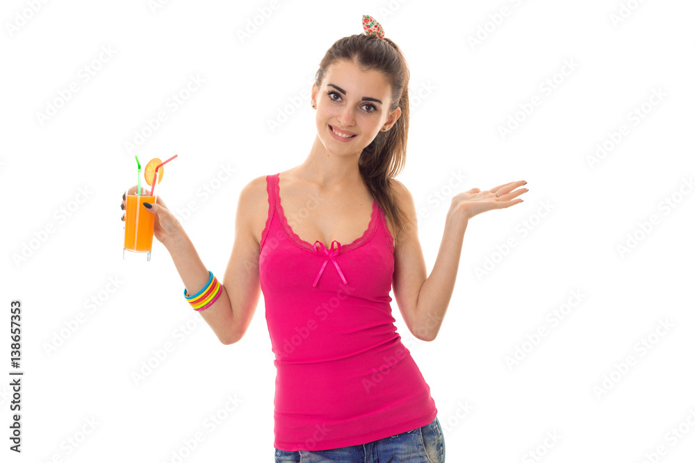 beautiful young girl in a pink shirt smiling and holding in his hand the juice isolated on white background beautiful young girl in a pink shirt smiling and holding in his hand the juice isolated on white background