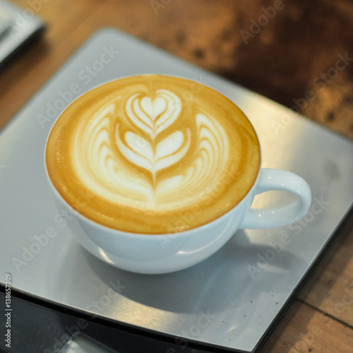 Coffee cup with latte art on the modern scale