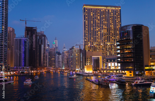 Panoramic night view on downtown of Dubai Marina with modern high skyscrapers. Architecture of future with bright lights and roads. Famous tourist destination © oleg_p_100