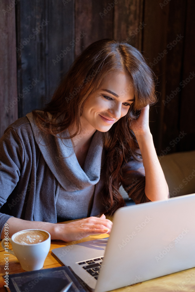 Portrait of a beautiful young woman working with a laptop Portrait of a beautiful young woman working with a laptop