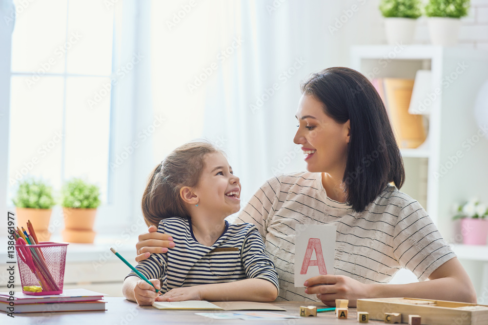 woman teaches child the alphabet