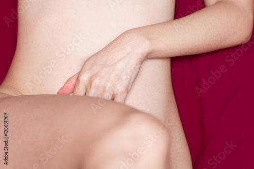 Woman hand sign orgasm on bed