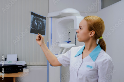 dentist analyzes a dental panoramic x-ray film