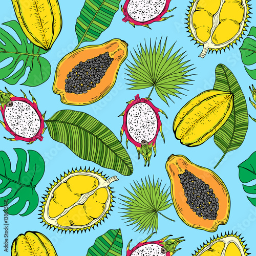 Pattern of tropical fruits and tropical leaves. On a blue background.