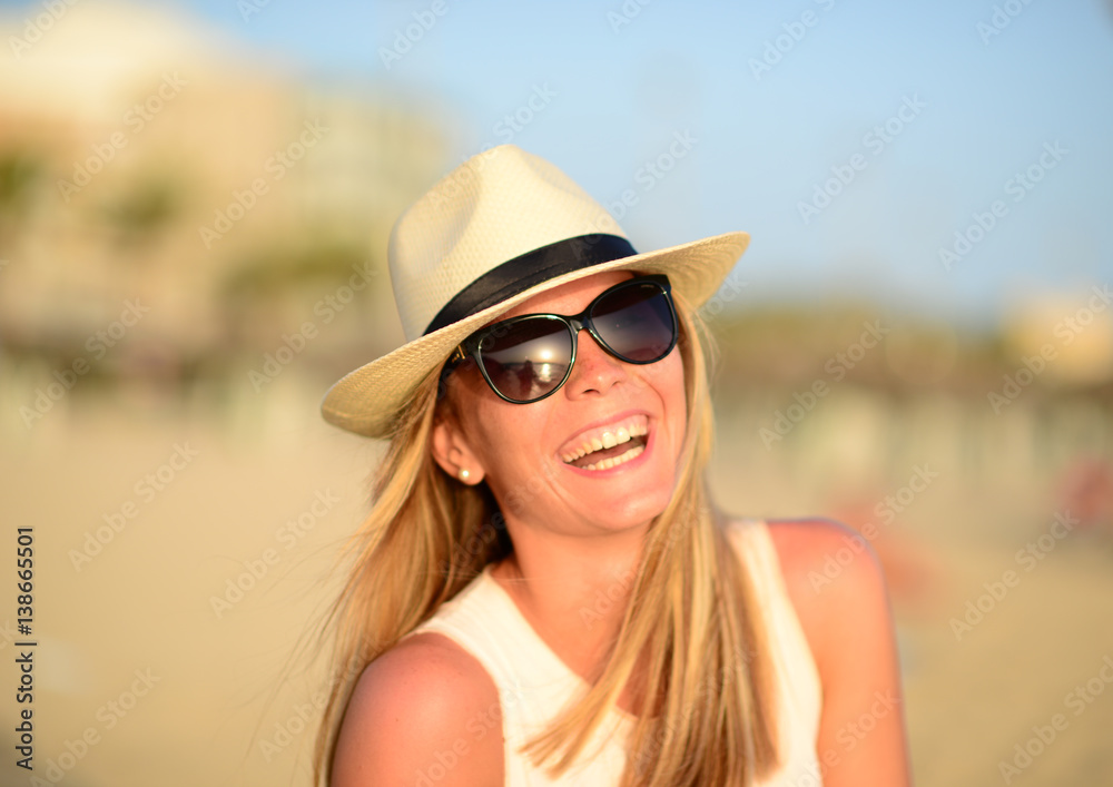 Beautiful happy smilin woman at beach during sunny summer day