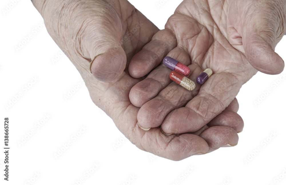 Pills on palm of a senior person Pills on palm of a senior person