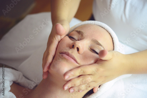 Close-up of a young woman getting Spa treatment at beauty salon - Spa Face Massage