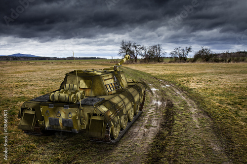 Photography Army tank on the muddy field under the dramatic sky.