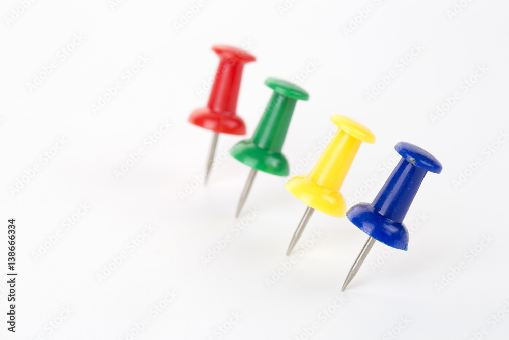 Four pins in different colors on the white background Four pins in different colors on the white background