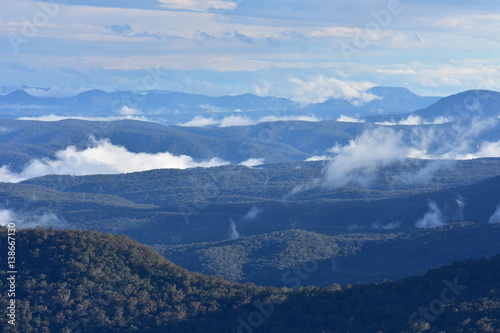 Blue Mountains with low patchy clouds in evening light.