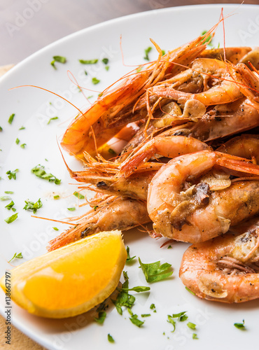Close up appetizer. Shrimps on plate with lemon. photo