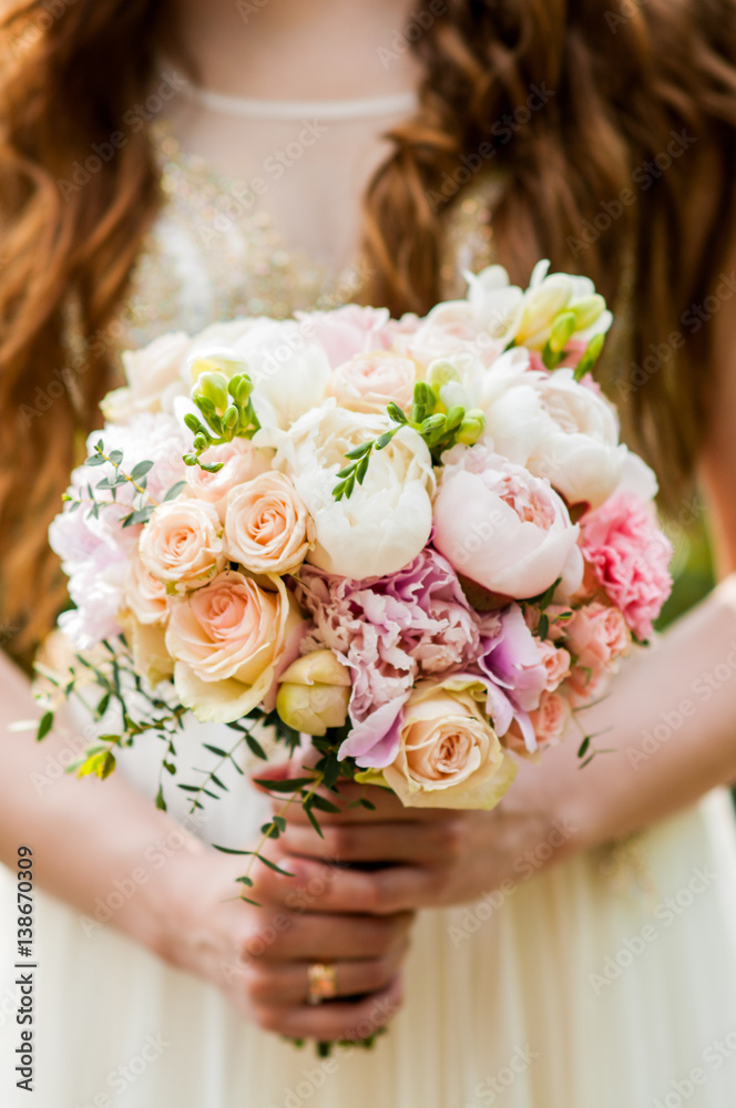 Wedding bouquet in hands of the bride Wedding bouquet in hands of the bride
