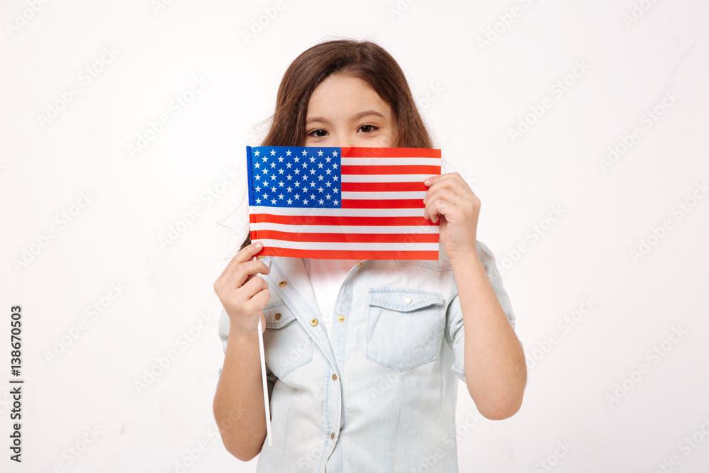 Shy child holding American symbolic in the studio Shy child holding American symbolic in the studio